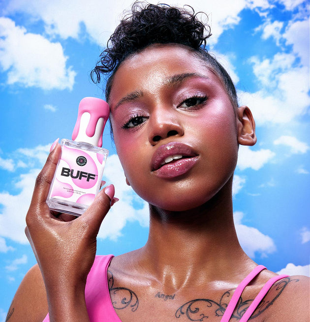 Model holding bottle of Buff silicone lubricant