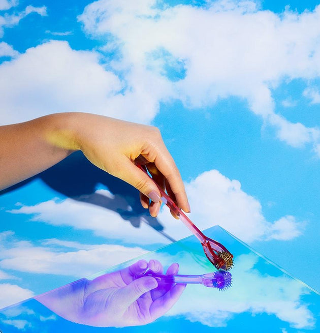 Hand holding Spike with a bright blue background with clouds