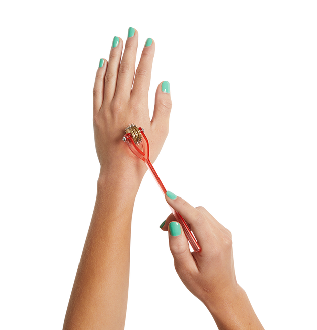 Hands with teal painted fingernails using Spike on the back of the hand