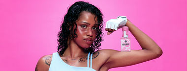 model flexing with unbound buff silicone lubricant on her bicep