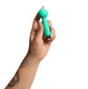 Hand holding a turquoise marker against a white background