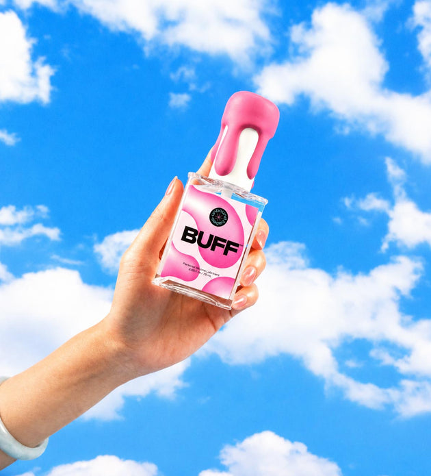 Hand holding bottle of Buff