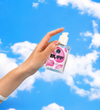 Hand holding bottle of Buff silicone lubricant, with cap off showing pump of bottle